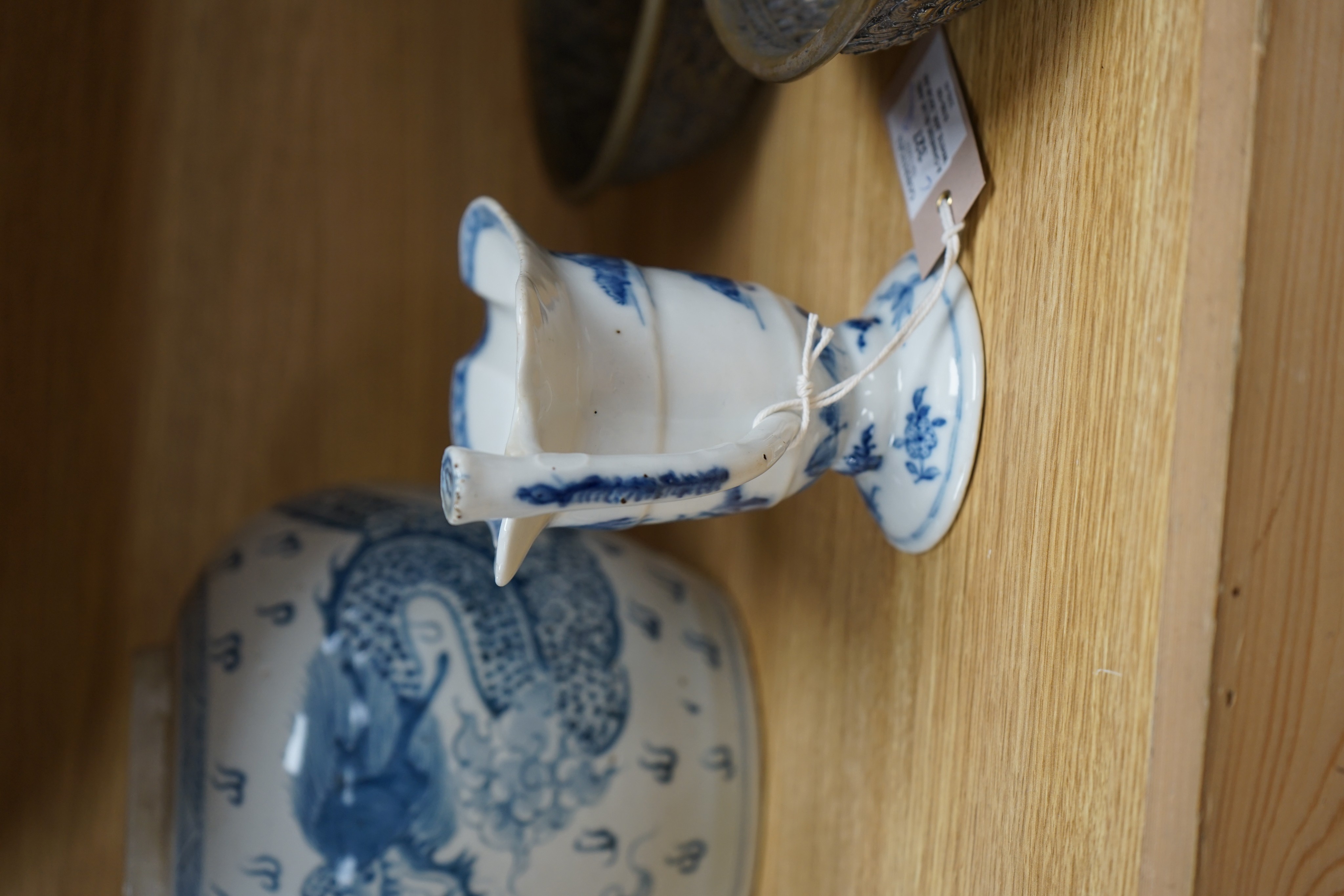 A Chinese blue and white jar, 20cm and a helmet shaped jug, 18th century and later